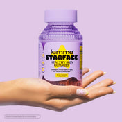 Hand holding a bottle of 'lemme STARFACE Healthy Skin Gummies' against a purple background
