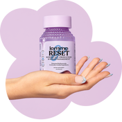 Hand holding a bottle of 'lemme RESET' supplement with a purple background